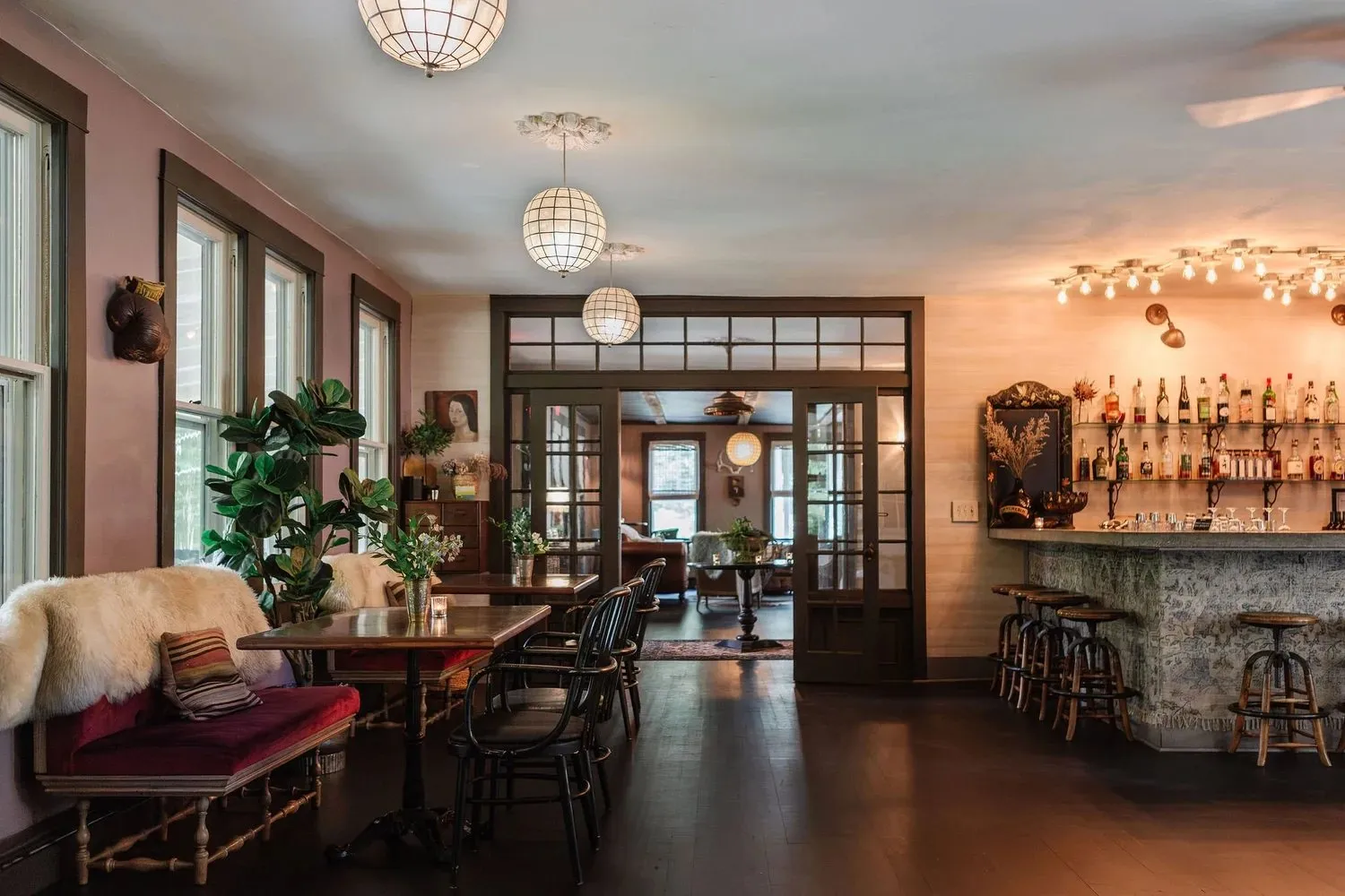 The bar room, warm lamps and long windows.