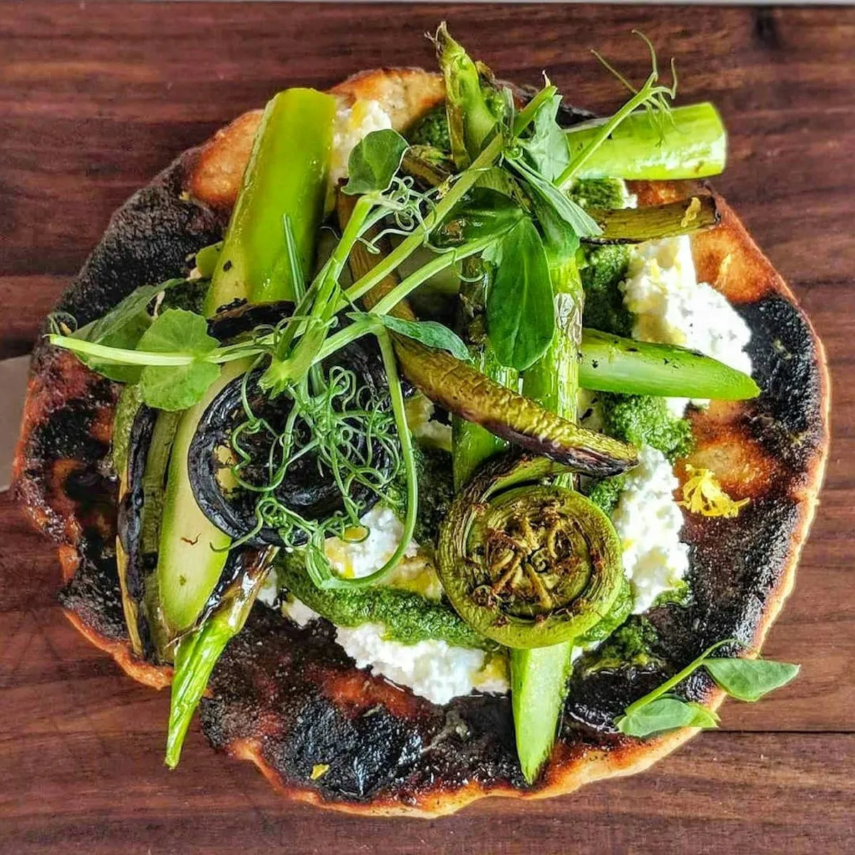 Charred flatbread with grilled greens and ricotta.